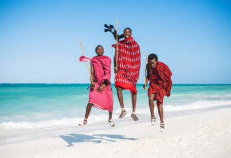 Masai warriors jumping on  a beautiful African beach (Zanzibar, Tanzania),